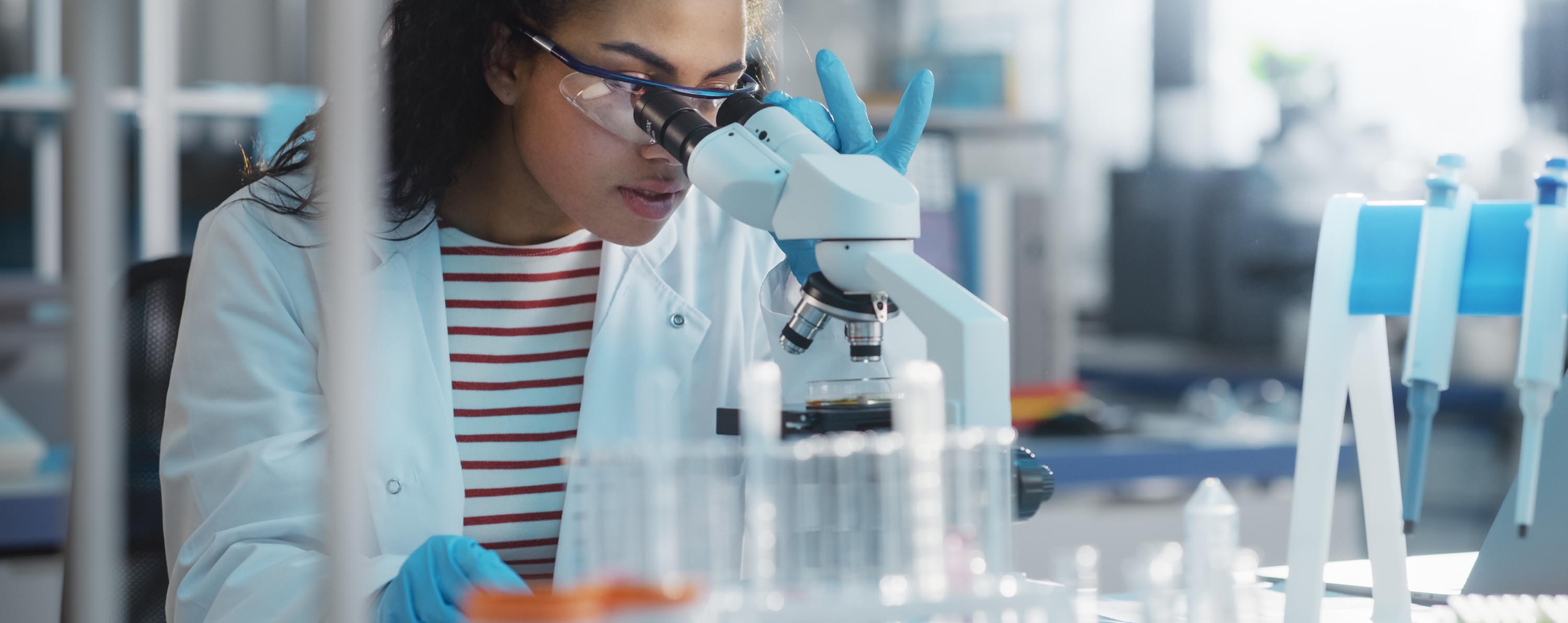 Researcher using a microscope
